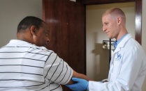 A medical student working with a patient. 